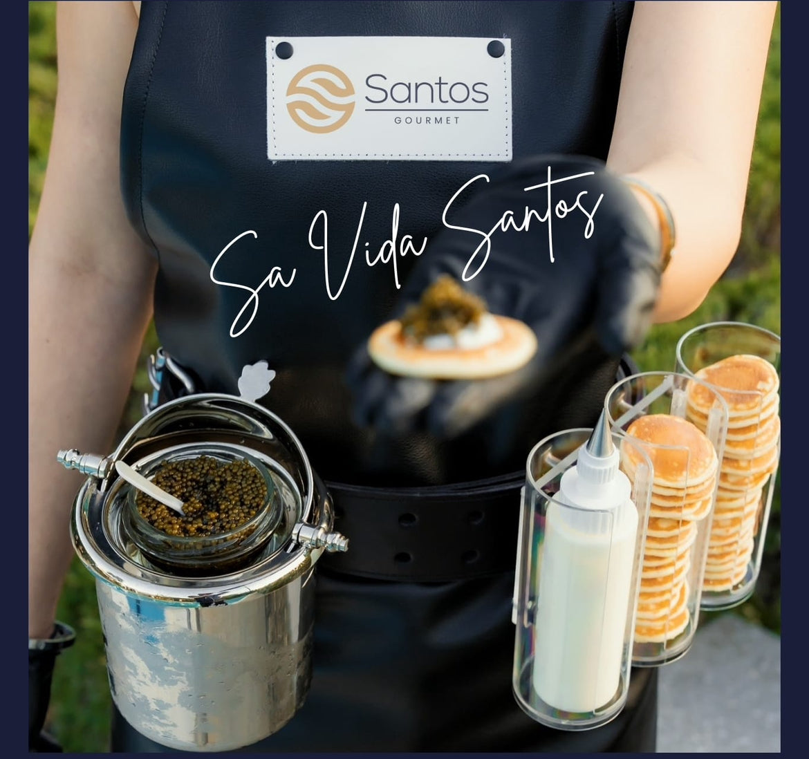Caviar Girl from Santos Gourmet serving caviar with blinis and crème fraîche, showcasing a stylish event experience.