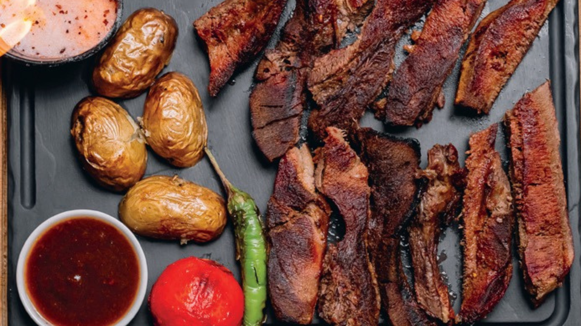 BBQ Package featuring smoky grilled meats and fresh sides by Santos Gourmet.