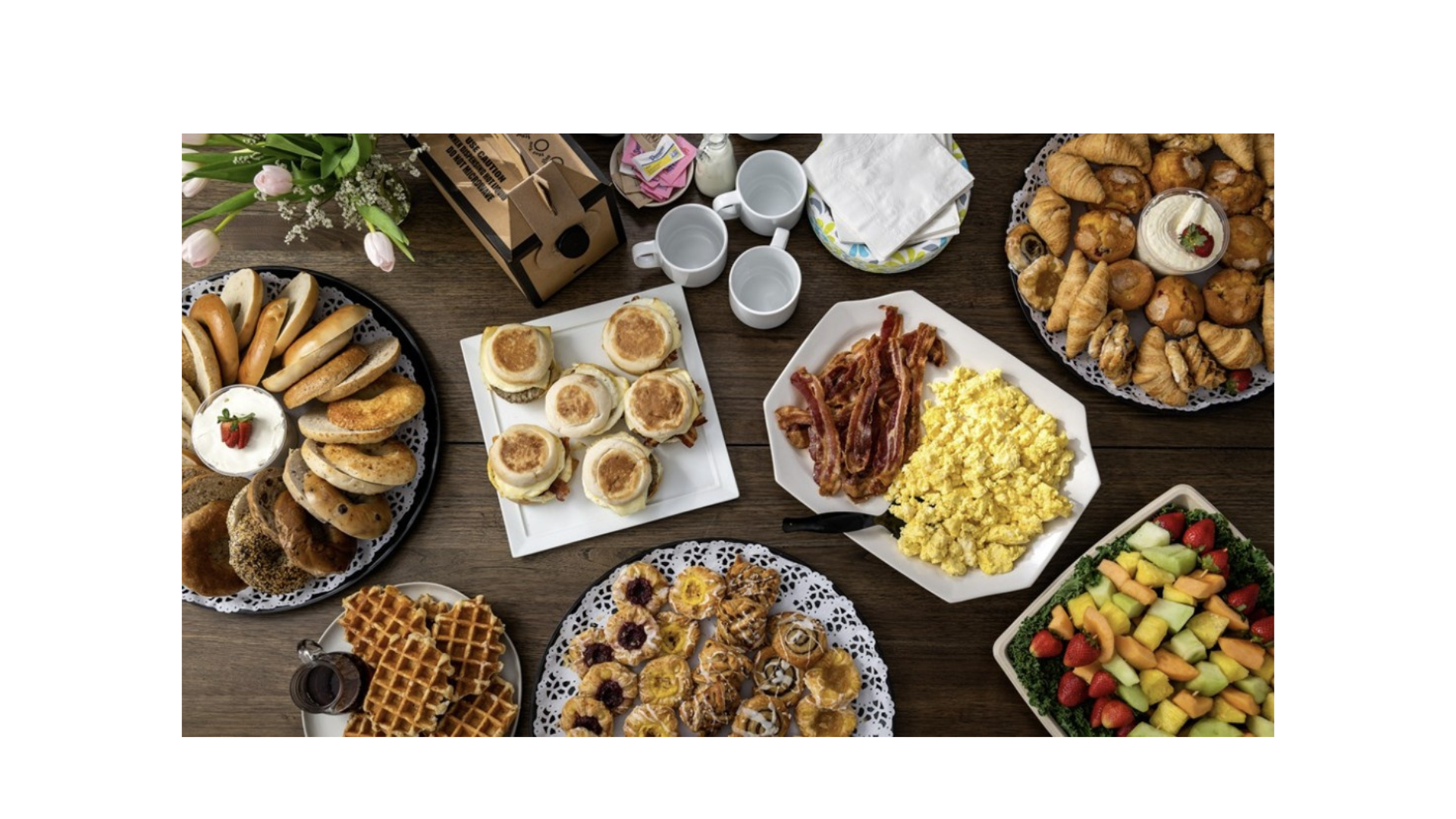 Santos breakfast menu featuring fresh fruits, sausage, cheese, eggs, and juice, perfect for a delicious start to your day.
